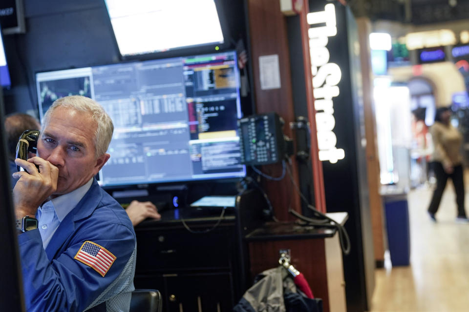 FILE — Trader Timothy Nick works on the floor at the New York Stock Exchange, Feb. 22, 2023. Average Wall Street bonuses dropped sharply last year amid lagging profits and recession fears, New York state's comptroller reported Thursday. (AP Photo/Seth Wenig, File)