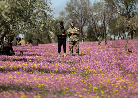 Turkish-backed Free Syrian Army fighters are seen praying in a field in eastern Afrin, March 9. REUTERS/ Khalil Ashawi