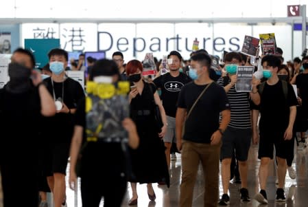 Anti-extradition bill demonstrators attend a protest at the departure hall of Hong Kong Airport