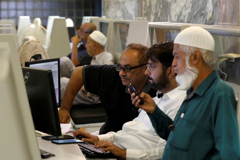 Stock brokers monitor the share market prices during trading a session at the Pakistan Stock Exchange, in Karachi