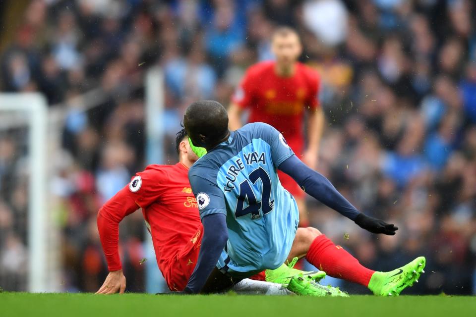 <p>Studs up: Yaya Toure launches into a dangerous tackle on Emre Can </p>