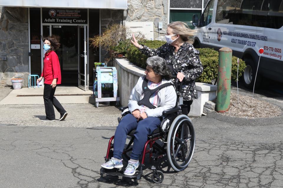 Adult Center Supervisor Lynne Hewitt-Delohery watches as Peggy Brarman wheels her daughter Melissa Christiana outside the North Jersey Elks Developmental Disabilities Agency in Clifton. The agency provides daily care, socialization and therapy to adults with developmental disabilities.