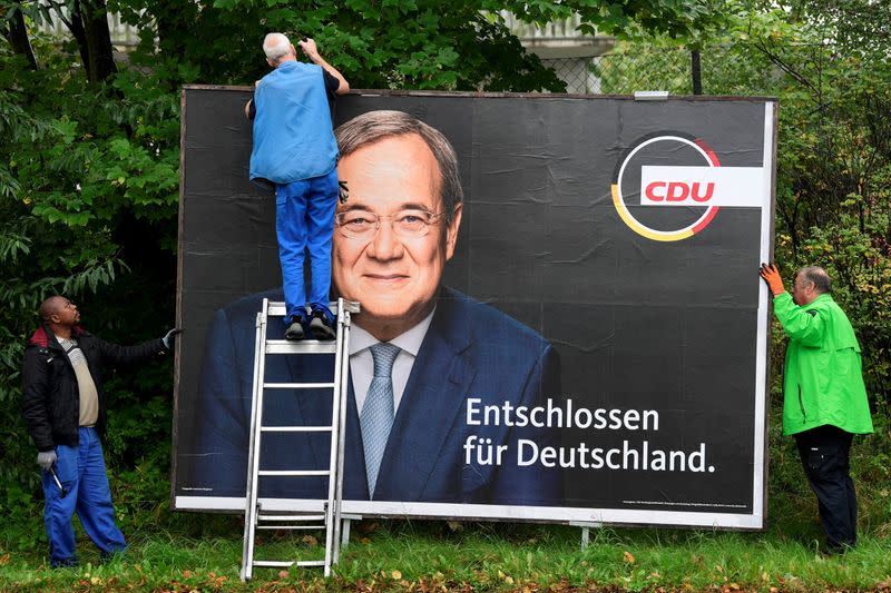 Workers remove election campaign posters after general election in Germany