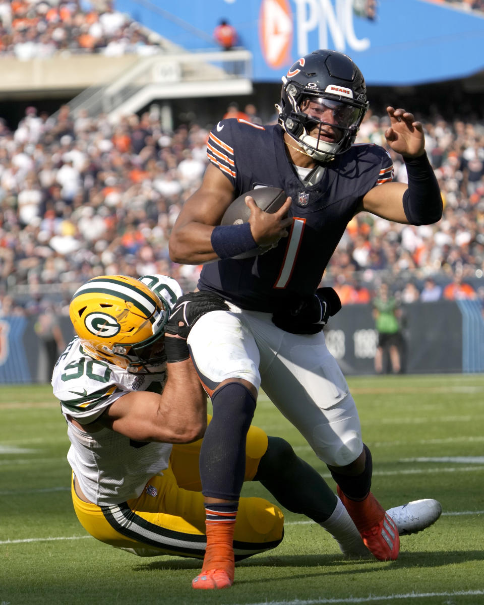 Chicago Bears quarterback Justin Fields (1) carries the ball and is tackled by Green Bay Packers linebacker Lukas Van Ness during the first half of an NFL football game Sunday, Sept. 10, 2023, in Chicago. (AP Photo/Nam Y. Huh)