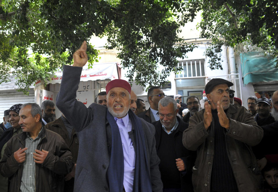 Supporters of the Tunisian Islamist movement Ennahda stage a protest in front of the justice ministry to denounce the arrest one of its senior leader in Tunis, Tunisia, Friday, Dec. 23, 2022. The protesters denounced the arrest of one of its senior leaders, suspected of being involved in sending Tunisians to fight with extremists in Syria. (AP Photo/Hassene Dridi)