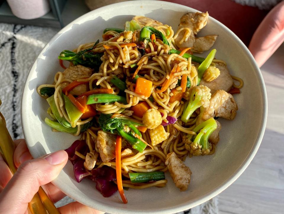A chicken stir-fry with noodles and vegetables.