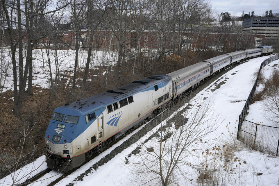 The Amtrak Downeaster travels through Portland, Maine, Wednesday, March 8, 202. The New Hampshire Liquor Commission says it is "exploring a creative solution" after saying an Amtrak route from Maine to Boston can't serve alcohol while passing through 35 miles of New Hampshire. (AP Photo/Robert F. Bukaty)