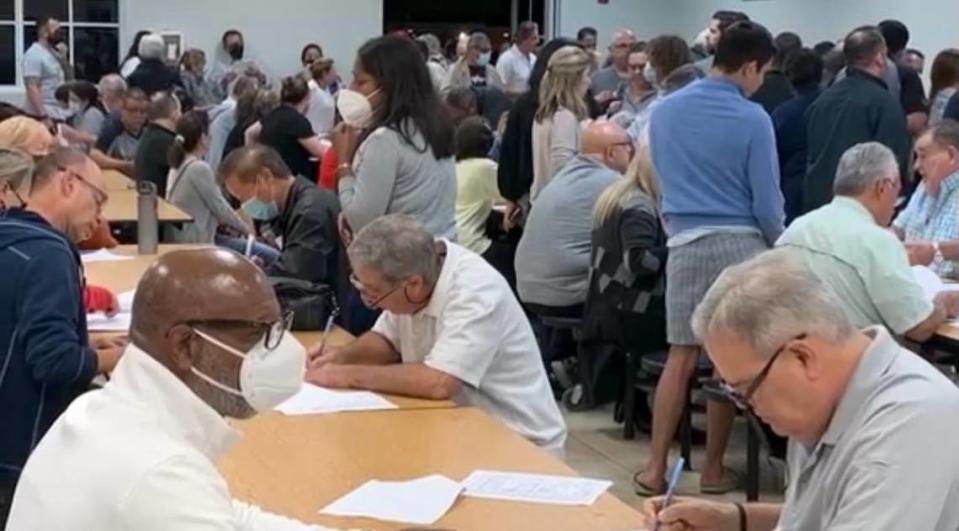 Hammocks residents at a Justice for the Hammocks meeting in 2022, signing petitions to recall the HOA board of directors. A court-appointed receiver is now trying to unravel the legal and financial mess left by the former board, some of whose leaders have been arrested and accused of siphoning $2 million from the homeowners.