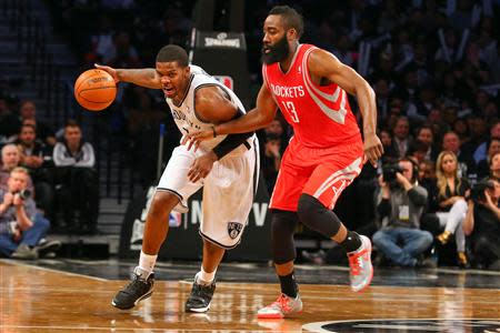 Apr 1, 2014; Brooklyn, NY, USA; Brooklyn Nets guard Joe Johnson (7) drives to the net past Houston Rockets guard James Harden (13) during the fourth quarter at Barclays Center. The Nets defeated the Rockets 105-96. Mandatory Credit: Ed Mulholland-USA TODAY Sports