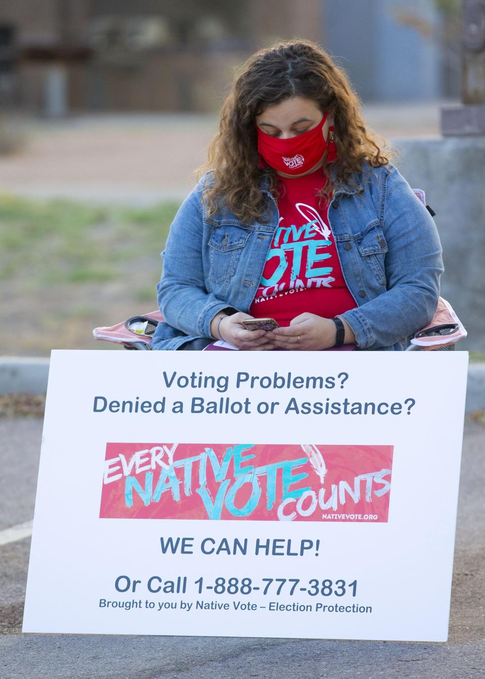 Anna Marie Smith, a volunteer with Native Vote, waits outside of Ak-Chin Service Center in Maricopa on Nov. 3, 2020, to see if voters need assistance casting their ballots.