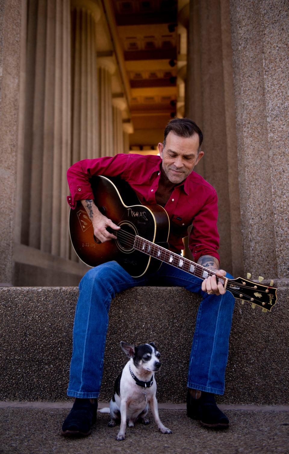 Waylon Payne sits with his dog, Petey, at the Parthenon at Centennial Park in Nashville , Tenn., Monday, Sept. 4, 2023.