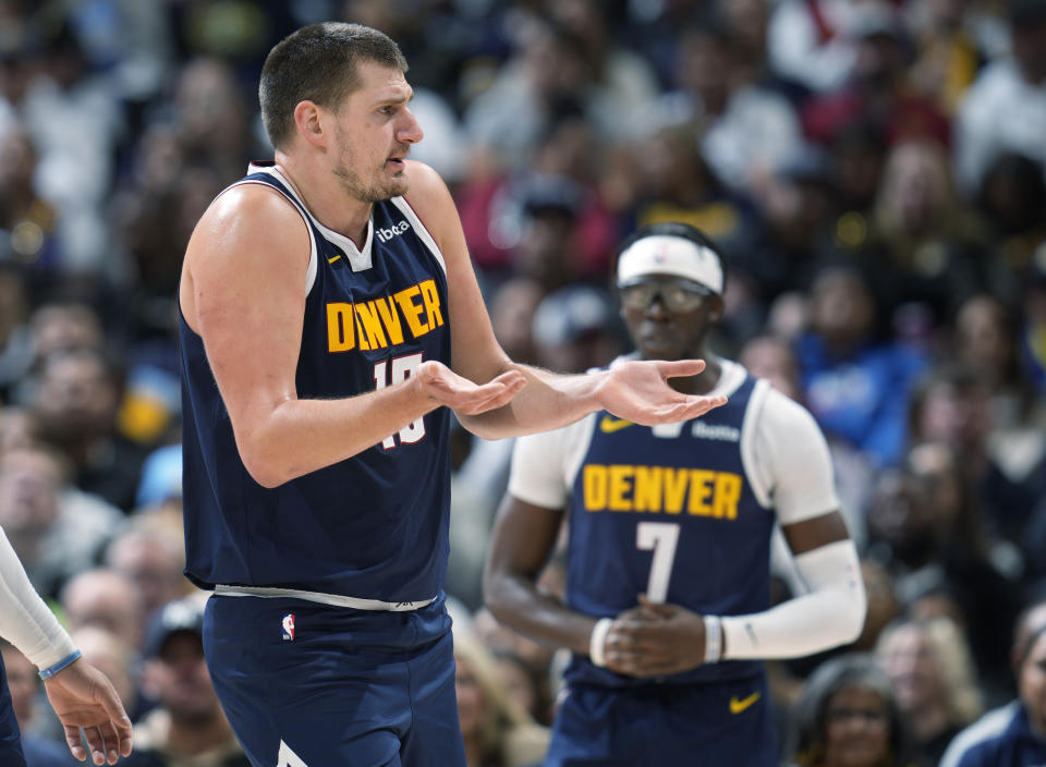 Denver Nuggets center Nikola Jokic, left, argues for a call in the first half of an NBA basketball game against the Utah Jazz, Monday, Oct. 30, 2023, in Denver. (AP Photo/David Zalubowski)