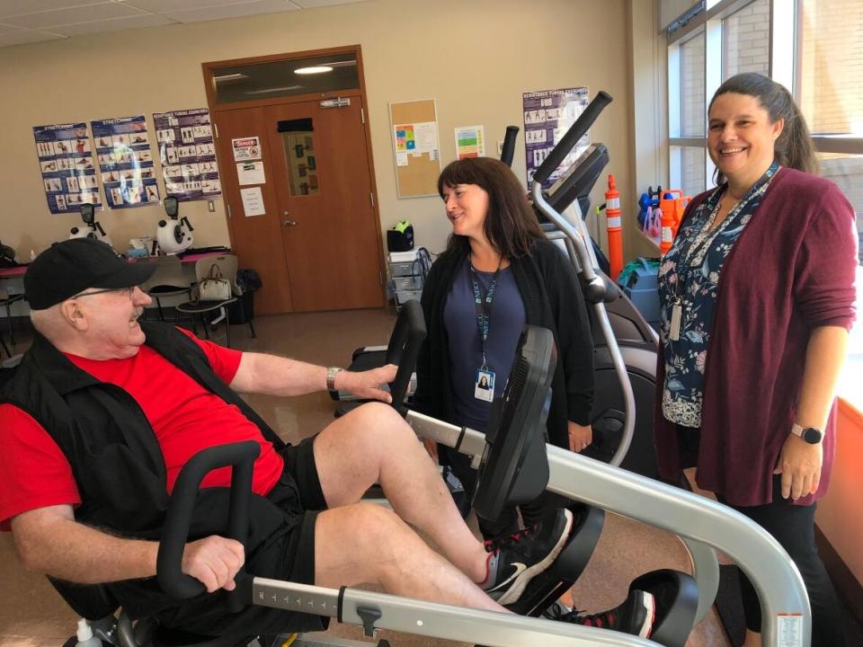 Neil Lydon jokes with program co-ordinators Lisa Curtis and Robyn Palk. (Megan Macalpine/CBC - image credit)