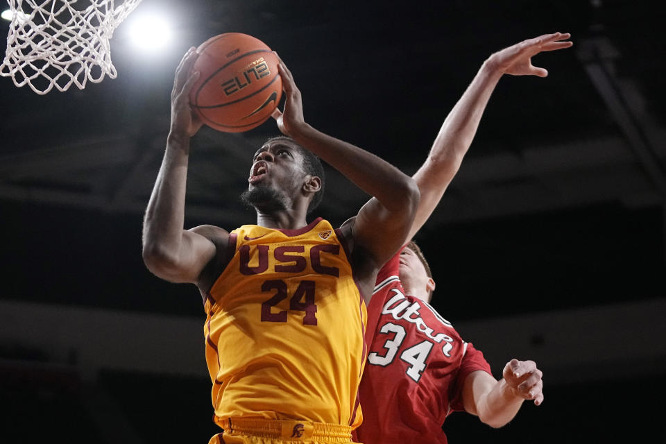 Southern California forward Joshua Morgan, left, shoots as Utah center Lawson Lovering defends during the first half of an NCAA college basketball game Thursday, Feb. 15, 2024, in Los Angeles. (AP Photo/Mark J. Terrill)