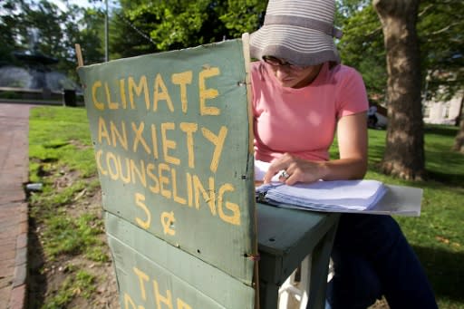 Kate Schapira, a 40-year-old senior lecturer in the English department at Brown University, mans her "climate anxiety" booth in Providence