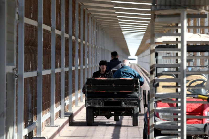 A Christian Palestinian couple riding an auto rickshaw leaves Gaza Strip through Israeli Erez crossing heading to Bethlehem to attend Christmas celebrations, in the northern Gaza Strip