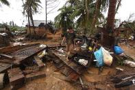 Residents walk among destroyed houses after Typhoon Bopha hit Compostela town, on the southern island of Mindanao. The death toll from a typhoon that ravaged the Philippines jumped to 274 Wednesday with hundreds more missing, as rescuers battled to reach areas cut off by floods and mudslides