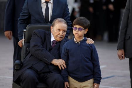 FILE PHOTO - Algeria's President Abdelaziz Bouteflika is pictured with his nephew after casting his vote during the local elections at a polling station in Algiers, Algeria November 23, 2017. REUTERS/Zohra Bensemra