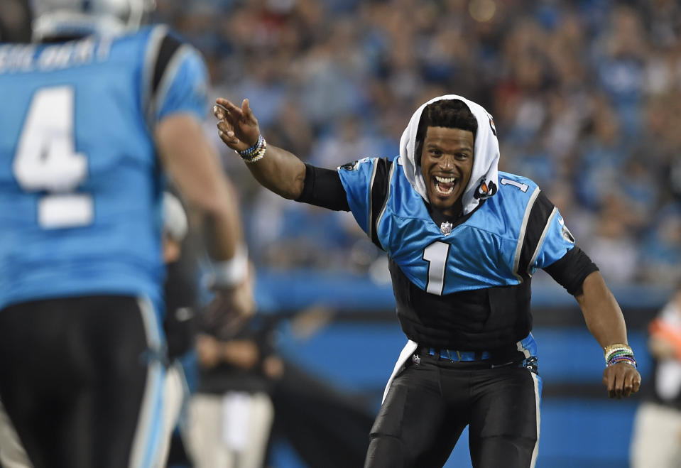 Carolina Panthers' Cam Newton (1) celebrates from the sidelines after a play against the New England Patriots during the second half of a preseason NFL football game in Charlotte, N.C., Friday, Aug. 24, 2018. (AP Photo/Mike McCarn)