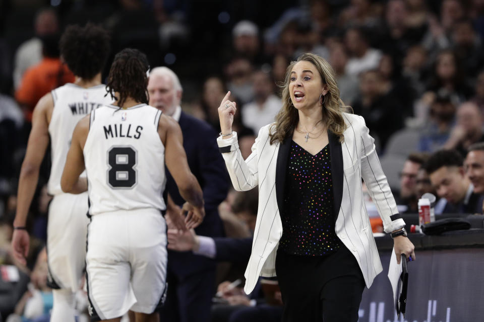 San Antonio Spurs assistant coach Becky Hammon signals to players during the first half of an NBA basketball game against the Toronto Raptors in San Antonio, Sunday, Jan. 26, 2020. (AP Photo/Eric Gay)