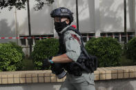 A police officer retreats after suffering injuries during a scuffle with protesters demonstrating against the new security law during a march marking the anniversary of the Hong Kong handover from Britain to China, Wednesday, July. 1, 2020, in Hong Kong. Hong Kong marked the 23rd anniversary of its handover to China in 1997, and just one day after China enacted a national security law that cracks down on protests in the territory. (AP Photo/Kin Cheung)