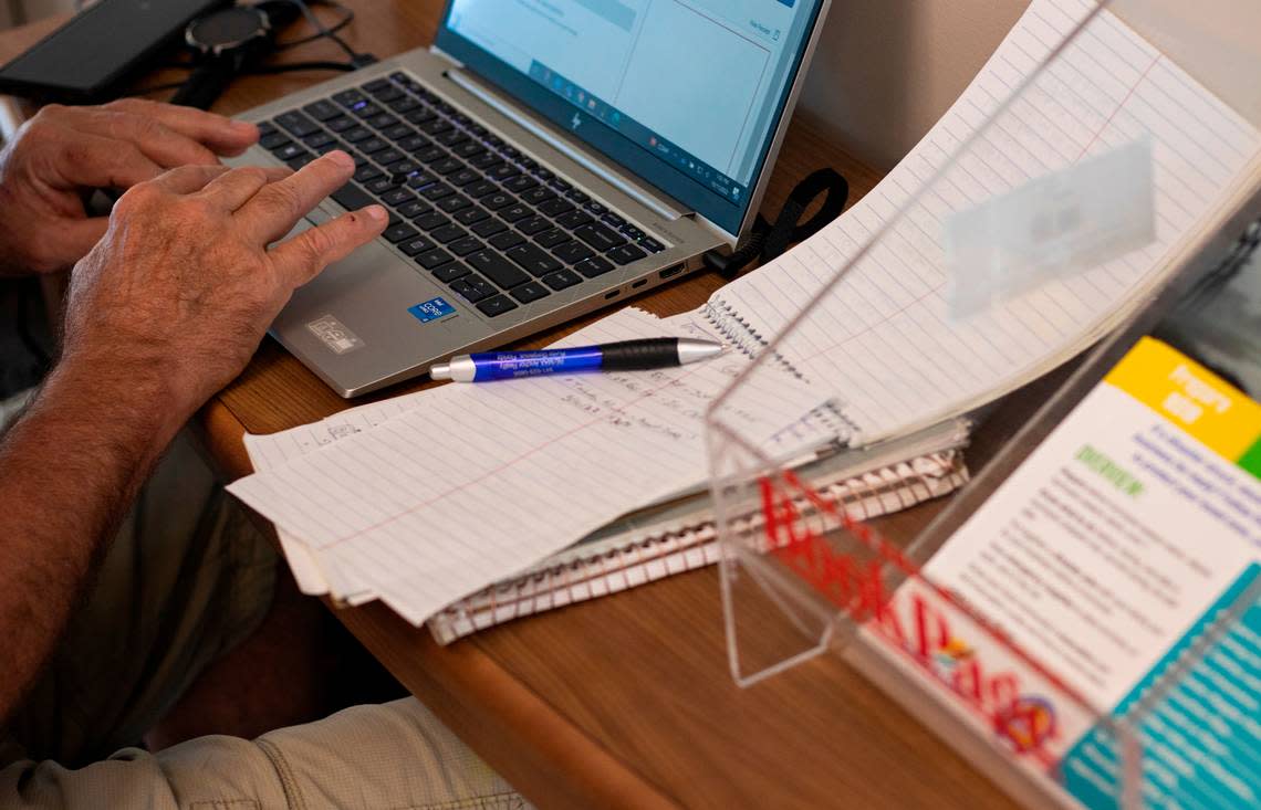 Mark Adkins, 63, Nationwide Financial CPA in compliance and ethics, works at a welcome desk that holds pamphlets at the Punta Gorda Charlotte Library on Tuesday, Oct. 11, 2022.