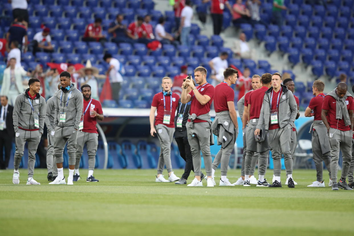 Flying away: England’s players walk on the pitch prior to the start of the group G match with Tunisia