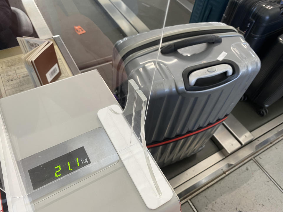 a suitcase being weighed at airport check in