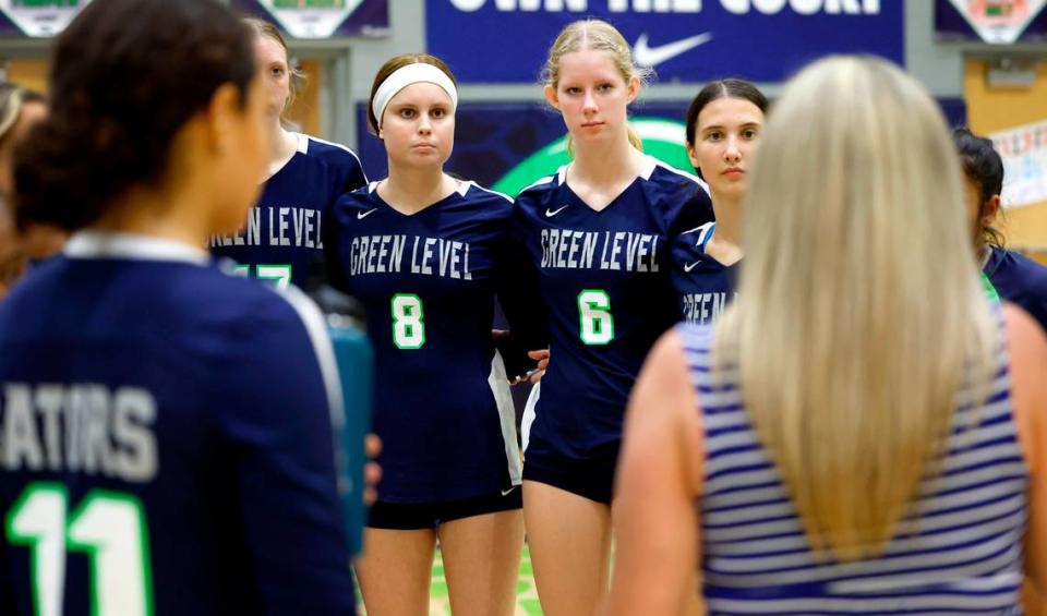 Green Level High School’s Reese Roper (8) huddles with her teammates, including Riley Taylor (6), during a timeout in Green Level’s volleyball game against Middle Creek at Green Level High School in Cary, N.C., Tuesday, Oct. 10, 2023.