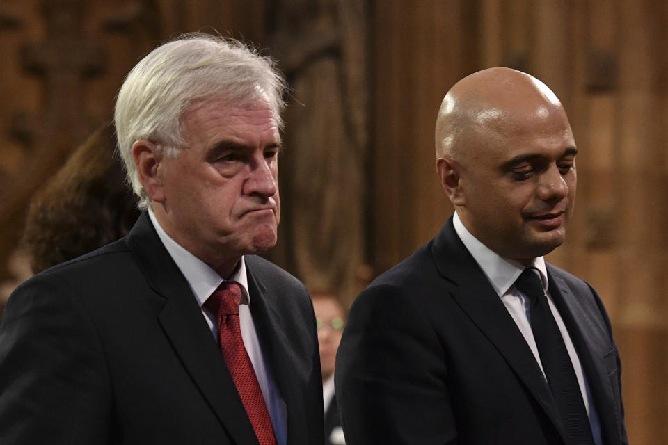 Chancellor of the Exchequer Sajid Javid (right) and Shadow chancellor John McDonnell in the Central Lobby as they walk back to the House of Commons after the Queen's Speech during the State Opening of Parliament ceremony in London.