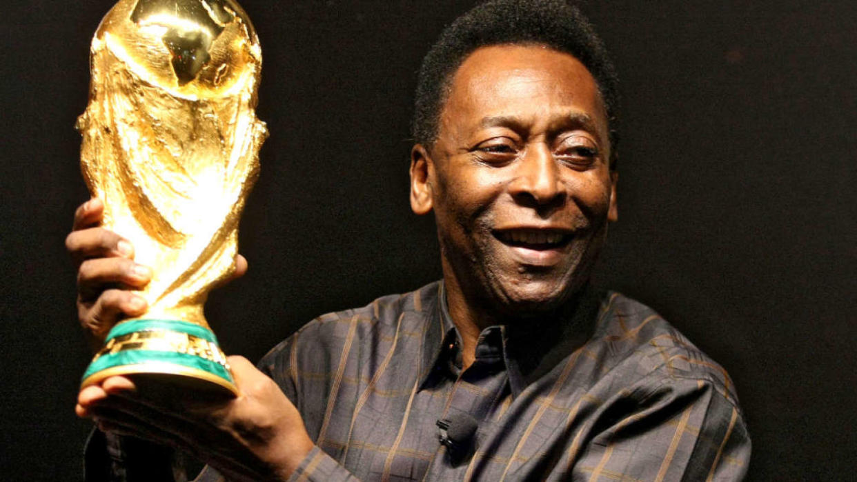 Brazilian football star Pele displays the FIFA World Cup during its presentation in Rio de Janeiro, Brazil on February 6, 2010. The cup is being exhibited in numerous countries while on a tour before reaching South Africa for the FIFA World Cup tournament that will be held next June. AFP PHOTO/GABRIEL LOPES (Photo credit should read GABRIEL LOPES/AFP via Getty Images)