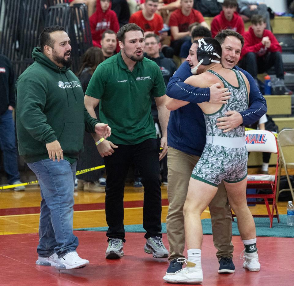 Colts Neck's Joe Layton celebrates with his coaches after he pinned Freehold's Joseph Berryman in the District 22 final Saturday.