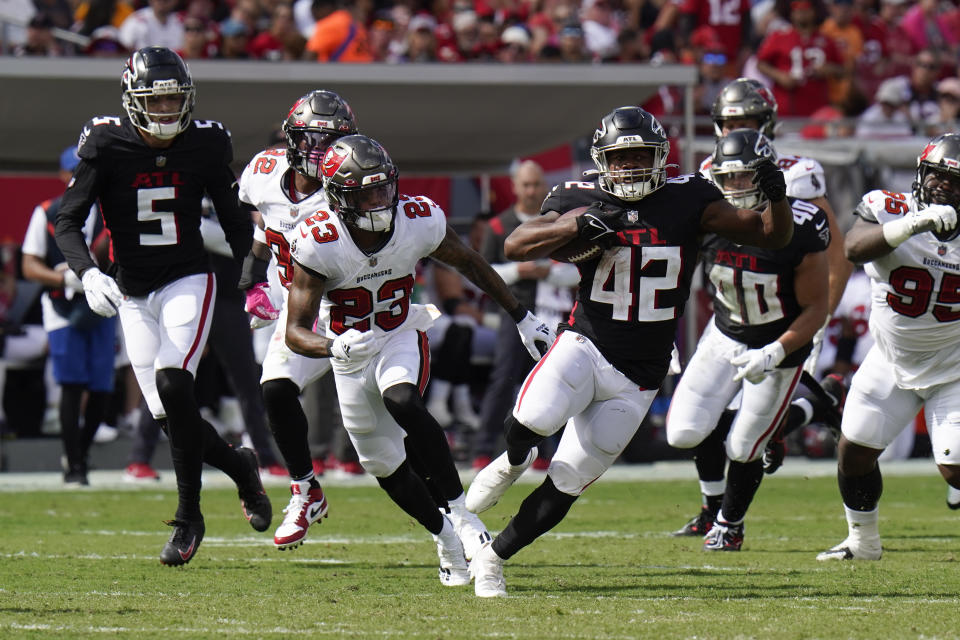 Atlanta Falcons running back Caleb Huntley (42) runs for a first down as Tampa Bay Buccaneers cornerback Sean Murphy-Bunting (23) gives chase during the second half of an NFL football game Sunday, Oct. 9, 2022, in Tampa, Fla. (AP Photo/Chris O'Meara)