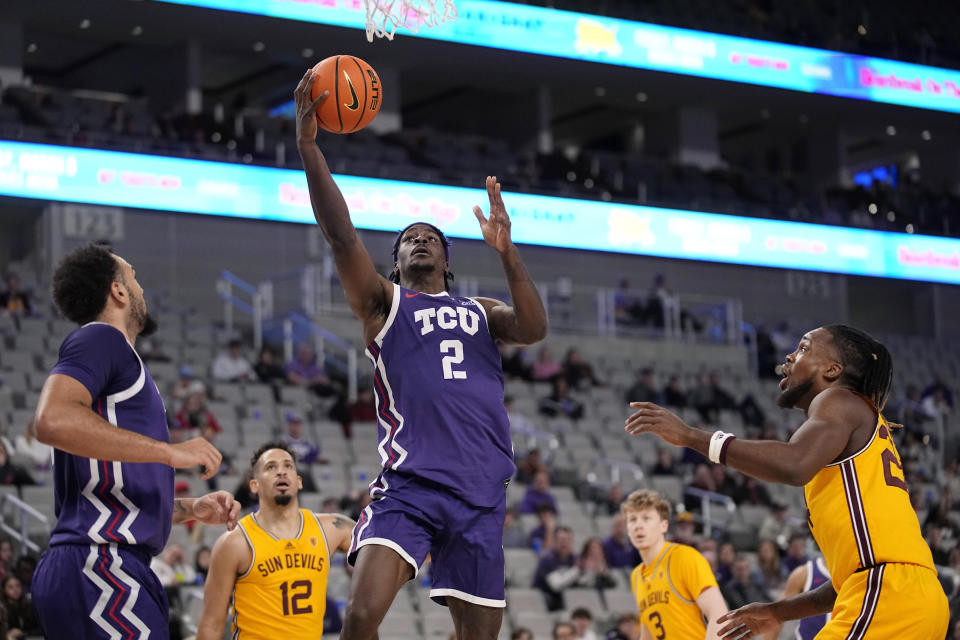 TCU forward Emanuel Miller (2) goes to to shoot between Arizona State's Jose Perez (12), Brycen Long (3) and Bryant Selebangue, right, during the first half of an NCAA college basketball game in Fort Worth, Texas, Saturday, Dec. 16, 2023. (AP Photo/Tony Gutierrez)