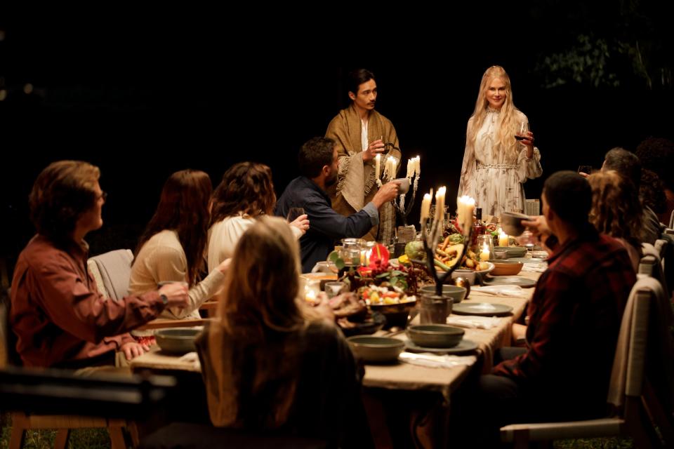 nine perfect strangers group sitting at dinner