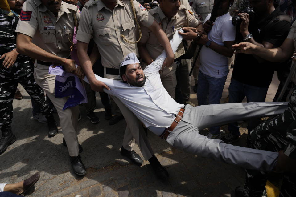 Policemen detain a member of Aam Admi Party, or Common Man's Party, during a protest against the arrest of their party leader Arvind Kejriwal in New Delhi, India, Tuesday, March 26, 2024. Indian police have detained dozens of opposition protesters and prevented them from marching to Prime Minister Narendra Modi’s residence to demand the release of their leader and top elected official of New Delhi who was arrested last week in a liquor bribery case. (AP Photo/Manish Swarup)