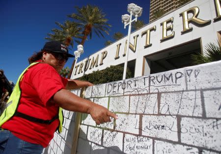 A protestor adjust a wooden wall at the Wall of Tacos demonstration in front of the Trump International Hotel Las Vegas before the last 2016 U.S. presidential debate in Las Vegas, Nevada, U.S., October 19, 2016. REUTERS/Jim Urquhart