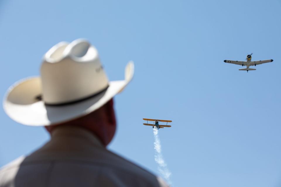 Funeral attendees watch Navel airplanes fly over the Coastal Bend State Veterans Cemetery after Capt. Robert "Bob" Batterson's service on Wednesday, Aug. 30, 2023, in Corpus Christi, Texas.