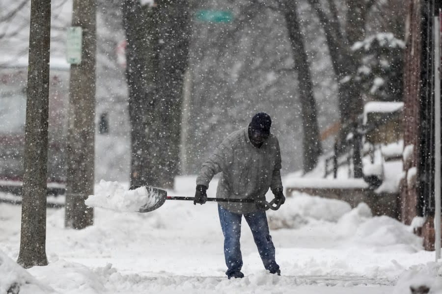 A man shovels as a winter storm arrives Friday, Jan. 12, 2024, in Milwaukee. (AP Photo/Morry Gash)