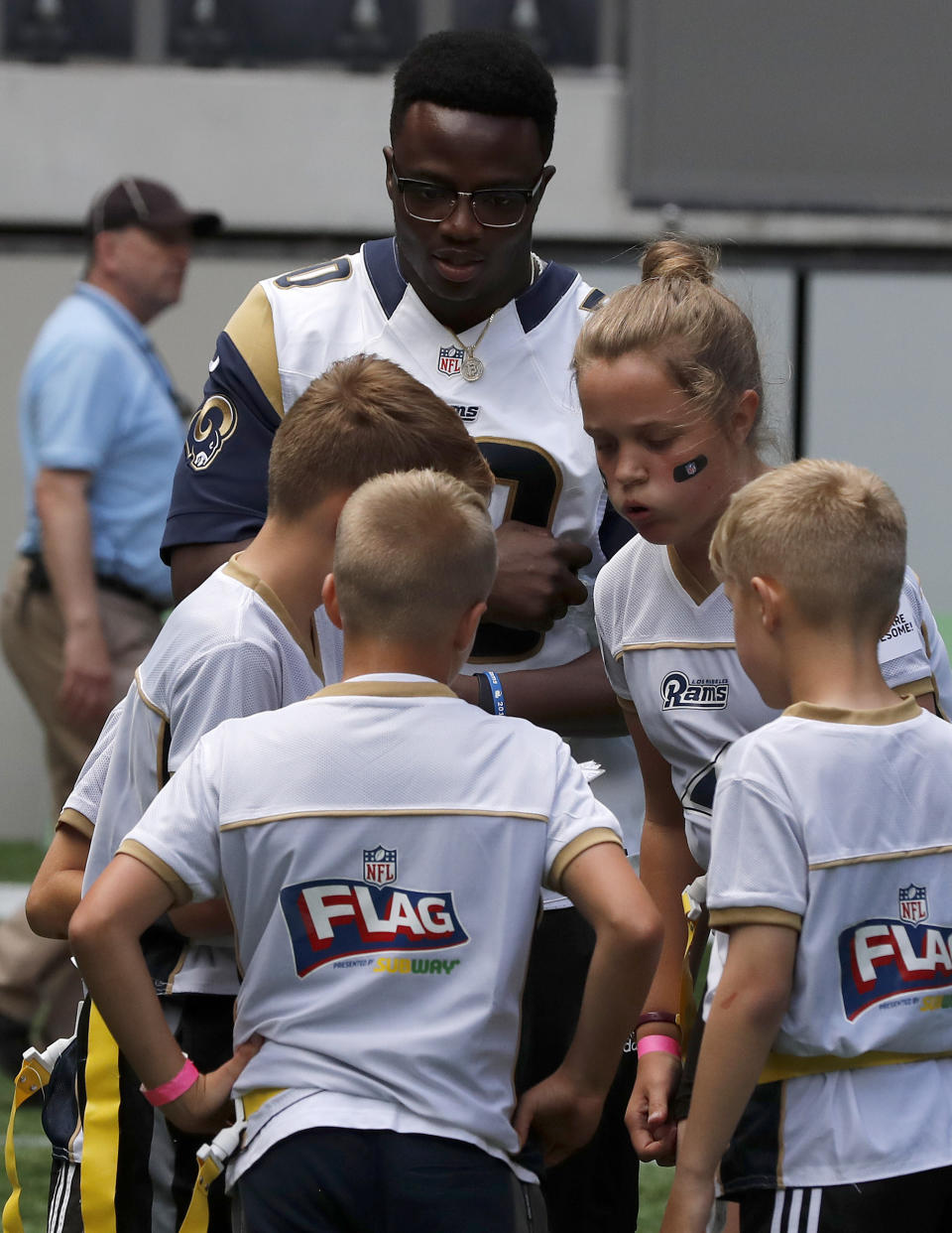 NFL player Samson Ebukam of the Los Angeles Rams coaches a young team during the final tournament for the UK's NFL Flag Championship, featuring qualifying teams from around the country, at the Tottenham Hotspur Stadium in London, Wednesday, July 3, 2019. The new stadium will host its first two NFL London Games later this year when the Chicago Bears face the Oakland Raiders and the Carolina Panthers take on the Tampa Bay Buccaneers. (AP Photo/Frank Augstein)