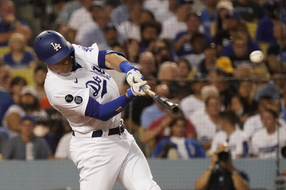 Los Angeles Dodgers' AJ Pollock drives in a run with a double during the fourth inning of the team's baseball game against the San Francisco Giants on Wednesday, July 21, 2021, in Los Angeles. (AP Photo/Marcio Jose Sanchez)