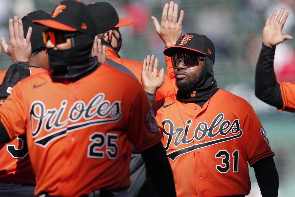 Baltimore Orioles' Cedric Mullins (31) and Anthony Santander (25) celebrate after defeating the Boston Red Sox baseball game, Saturday, April 3, 2021, in Boston. (AP Photo/Michael Dwyer)