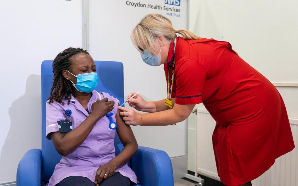 Catherine Cargill receiving the first Covid-19 booster jab, administered at Croydon University Hospital, south London - Dominic Lipinski/PA