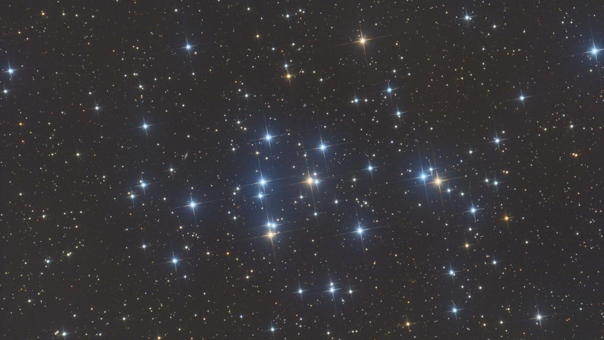  Several bright stars of the Beehive Cluster, a group of roughly 1,000 tight-knit stars  