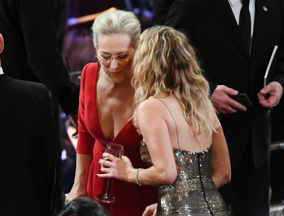 Lawrence getting friendly with Meryl Streep. (Photo: Kevin Winter via Getty Images)