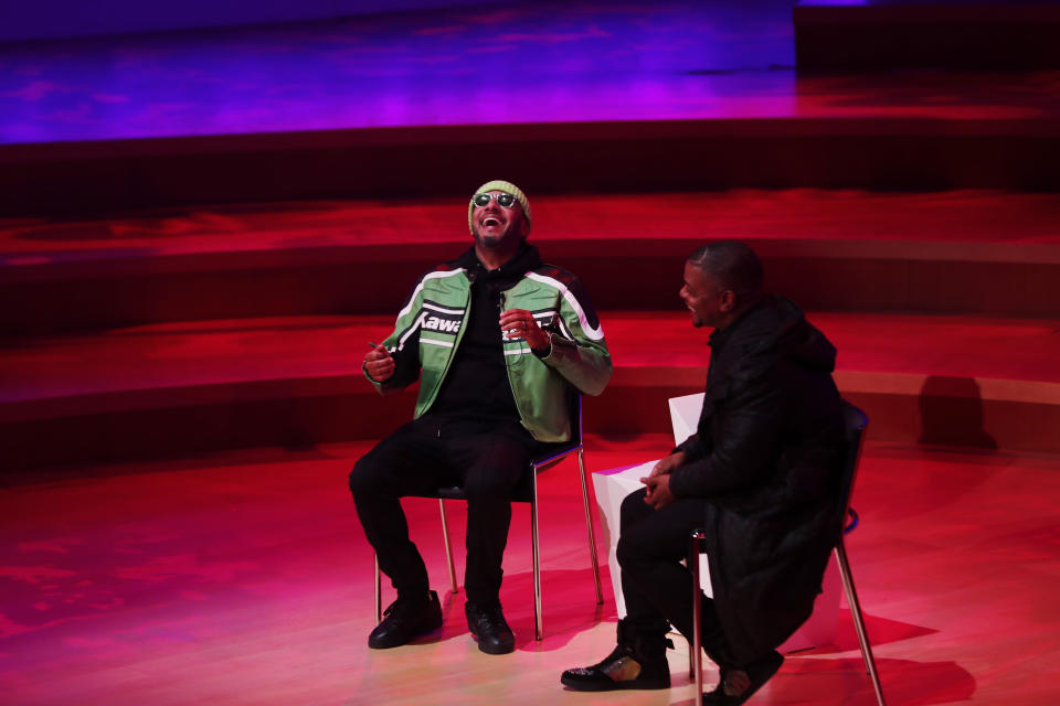 Kehinde Wiley, right, and Swizz Beatz speak during Art Basel, Monday, Dec. 2, 2019, in Miami Beach, Fla. (AP Photo/Brynn Anderson)