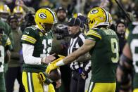 Green Bay Packers' Aaron Rodgers (12) and Christian Watson (9) celebrate after hooking up for a touchdown during the second half of an NFL football game against the Dallas Cowboys Sunday, Nov. 13, 2022, in Green Bay, Wis. (AP Photo/Matt Ludtke)