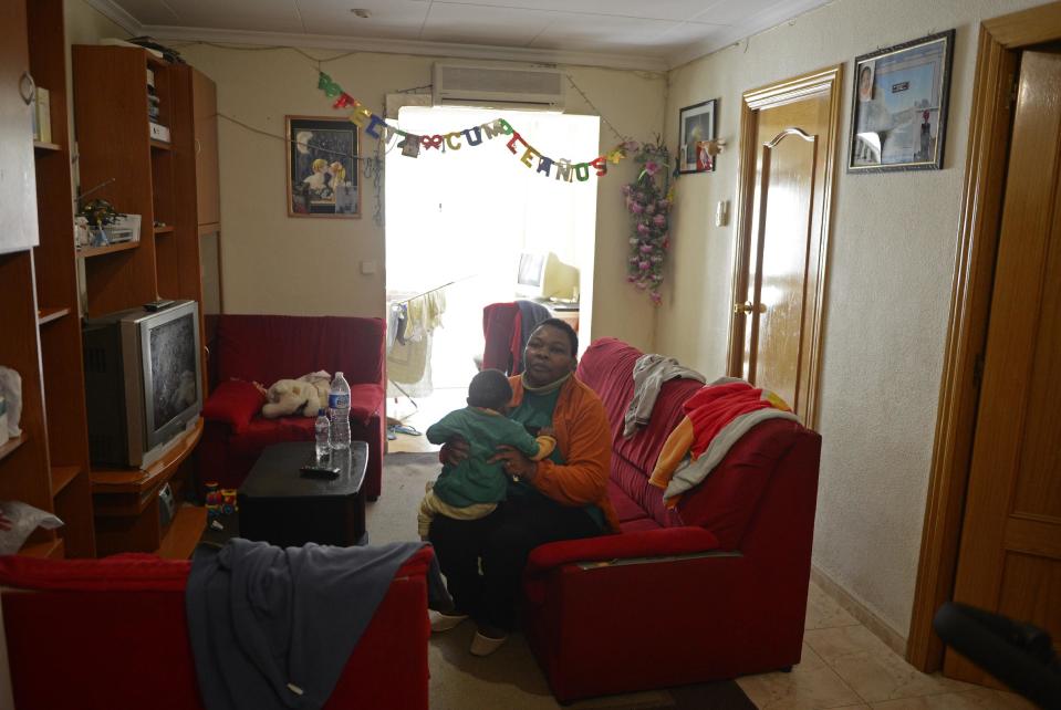 Perpetua Obi waits her eviction with her son in Santa Coloma de Gramanet, Spain, Thursday, Nov. 15, 2012. The Spanish government on Thursday passed a decree suspending evictions of the most vulnerable homeowners unable to pay their mortgage, a bid to ease a trend that has seen hundreds of thousands of people lose their homes because of the brutal economic crisis. The eviction was finally suspended. (AP Photo/Manu Fernandez)