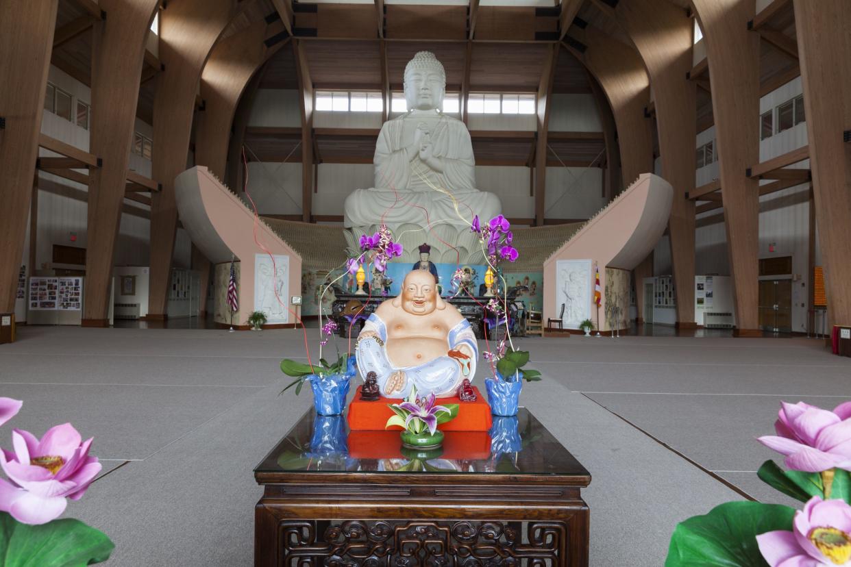 Carmel, NY USA - August 17, 2014: Great Buddha statue in Chuang Yen Monastery the biggest Buddha statue in Western hemisphere with laughing Buddha in front