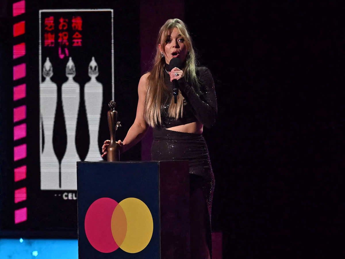 British singer Becky Hill celebrates after receiving the best dance act of the year award during BRIT Awards 2023 (AFP/Getty)